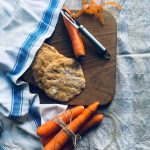 Sourdough flatbread with carrots on a wooden board.