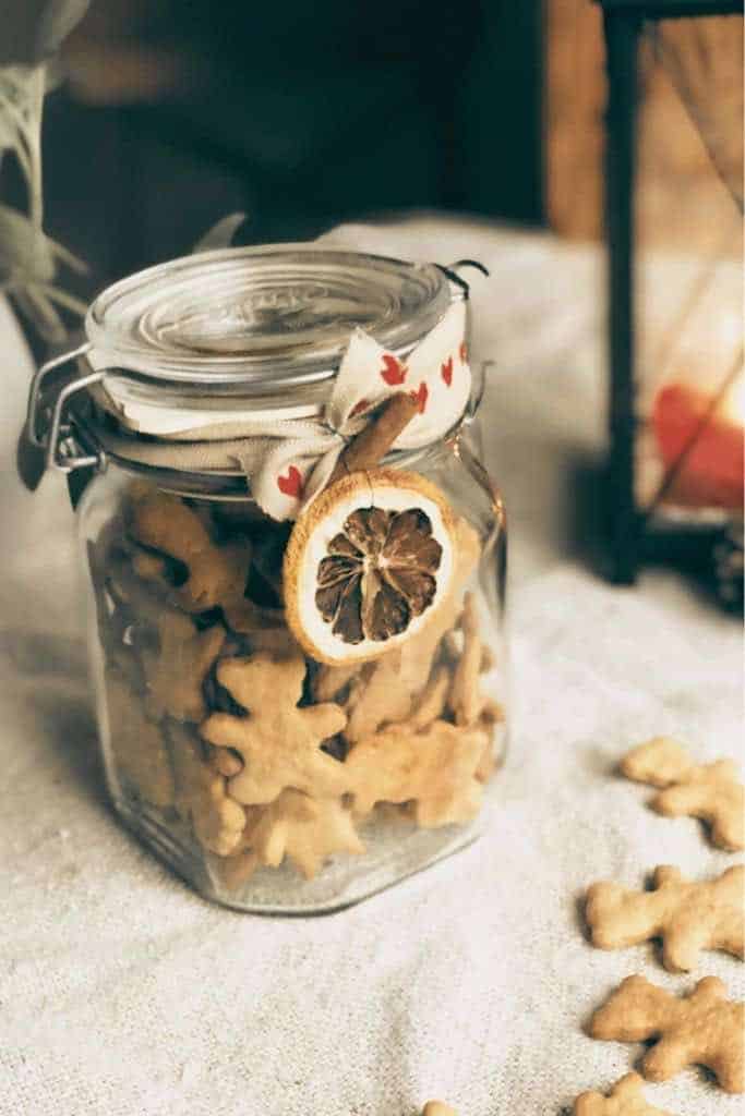 Nordic Orange gingerbreads in a thrifted glass jar on a natural colored jute fabric.