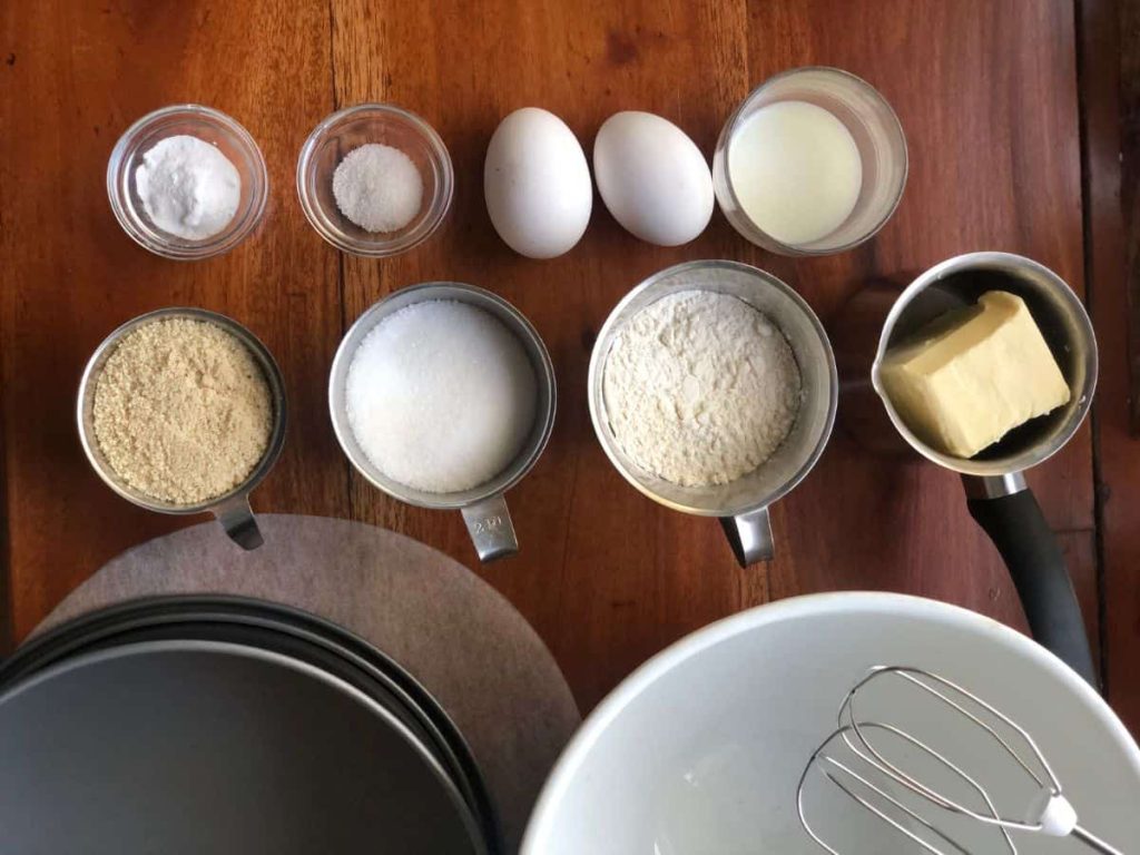 Tosca cake batter ingredients like wheat flour, almond meal, butter, milk and eggs.
