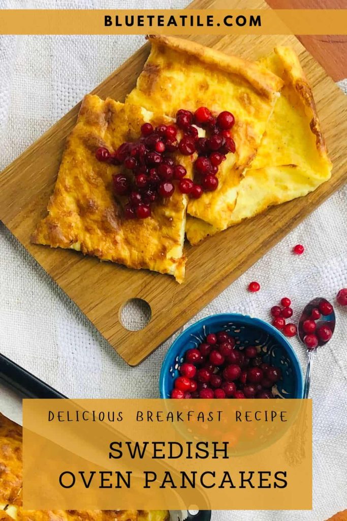 Swedish oven pancake squares on a wooden board served with smushed lingonberries.