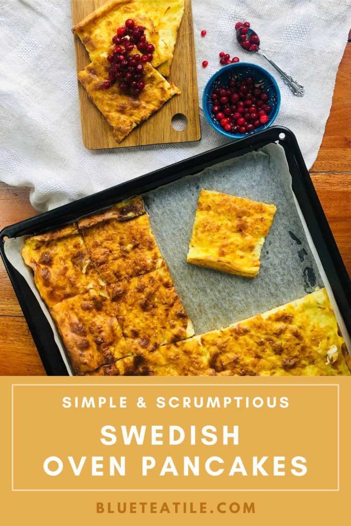 Swedish oven pancake on an oven pan cut into squares and served on a wooden board with lingonberries.