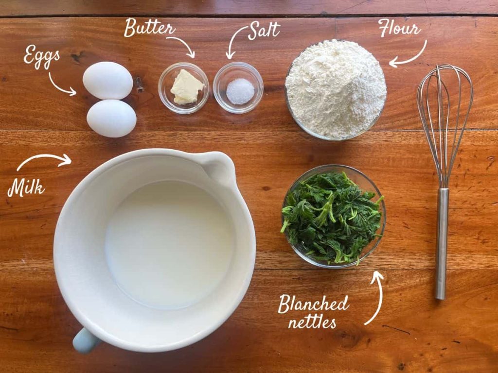 Ingredients for nettle pancakes on the table: Milk, blanched nettles, eggs, butter, salt and flour.