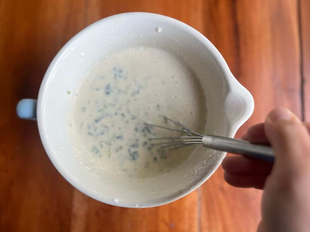 Nettle pancake batter in a bowl.