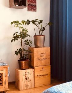 Plant stairs built out of different styled wine boxes with two plants on them.