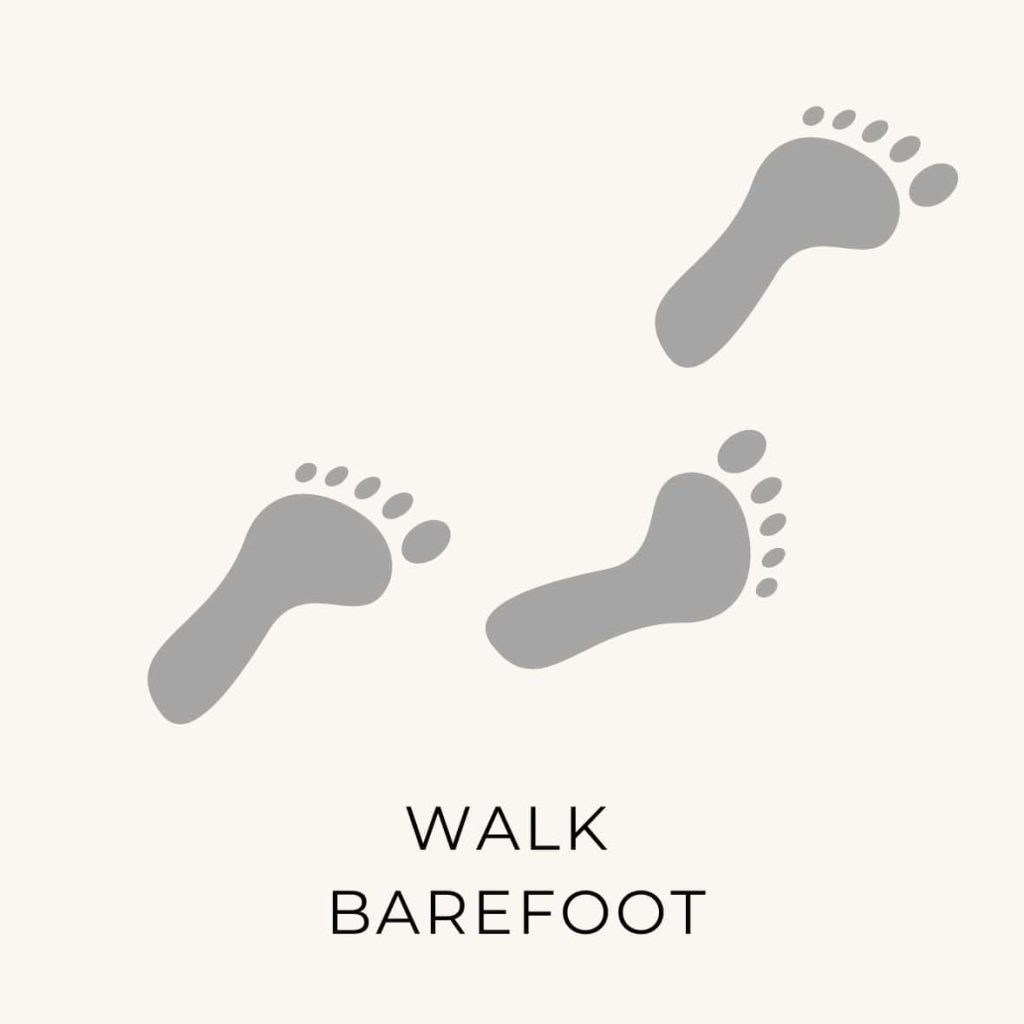 Foot prints with the text "walk barefoot" as a thing to do on the natural living bucket list.