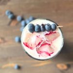 Iced blueberry latte from above with homemade blueberry simple syrup.