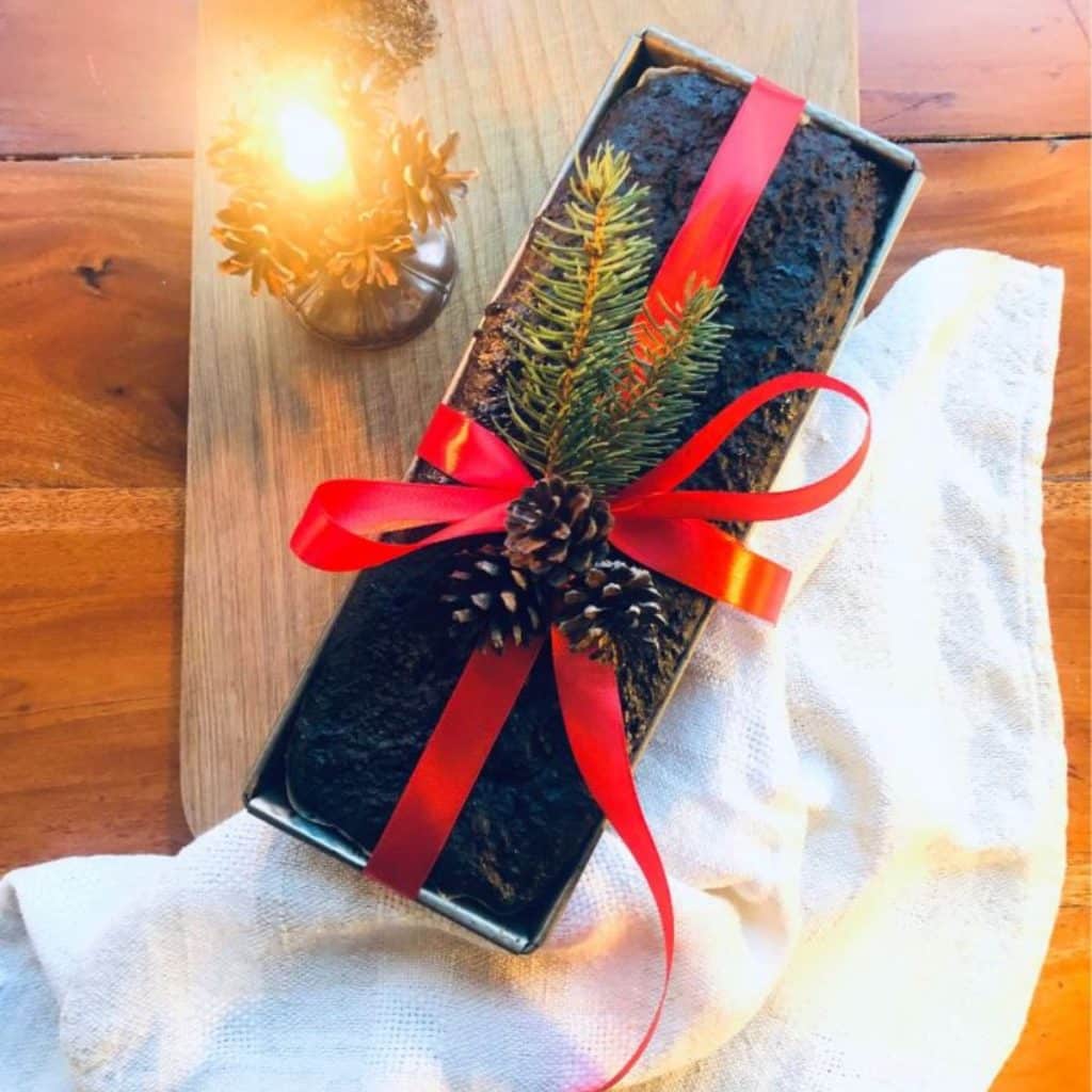 Finnish sweet rye bread, saaristolaisleipä in the bread tin and wrapped with red silk ribbon as a Christmas gift.