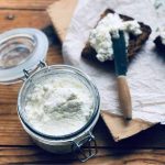 Soft kefir cheese in a jar and spread on the top of a sweet rye bread.