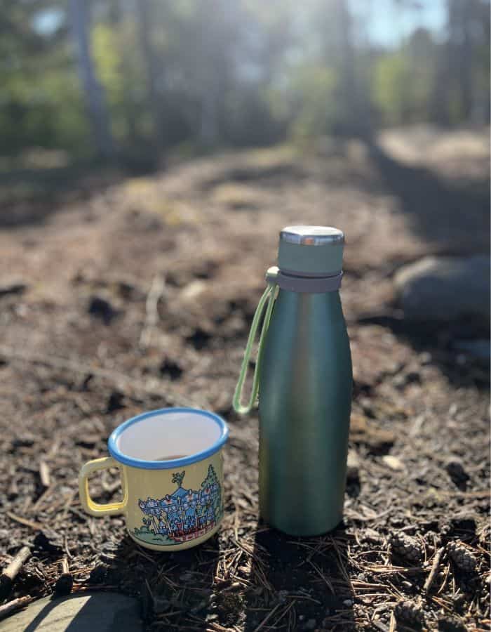 Reusable thermos bottle with an enamel mug.
